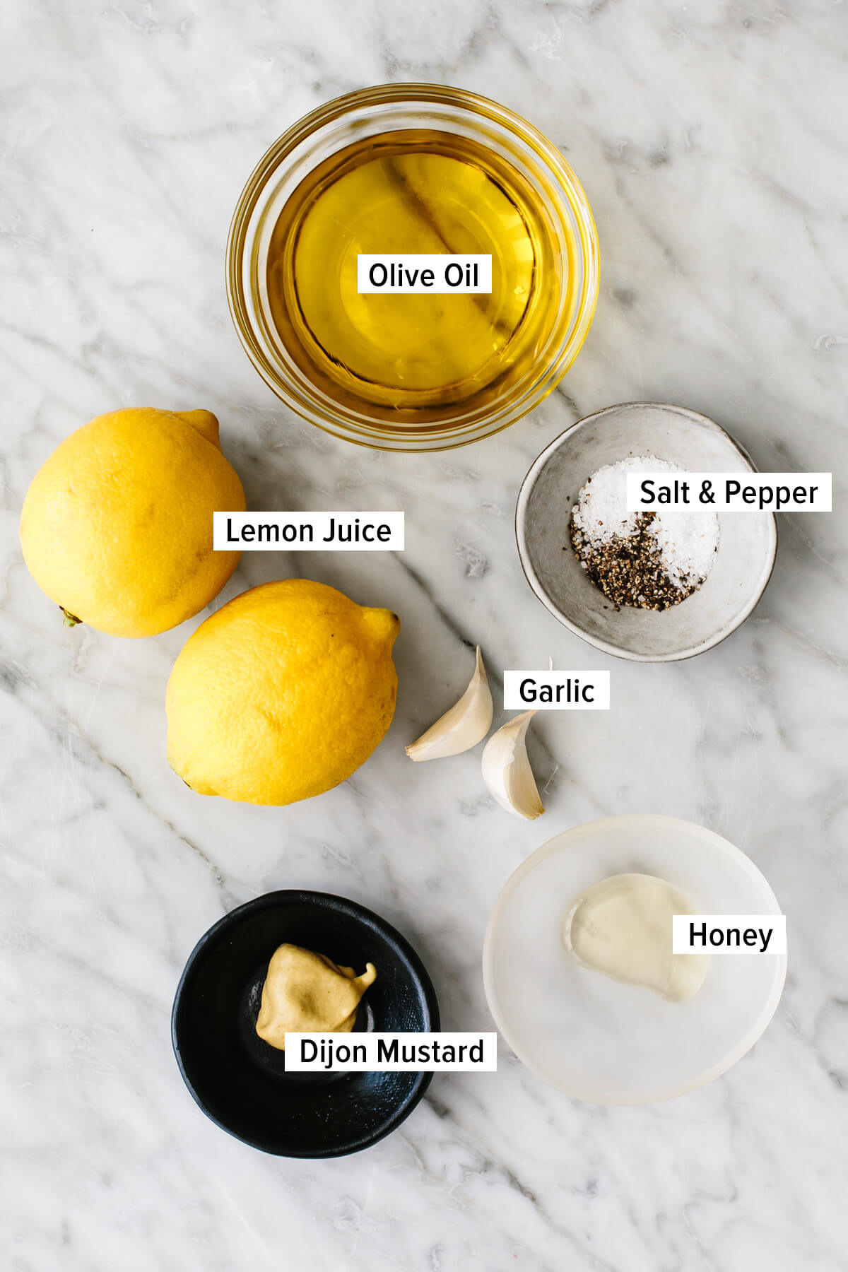 Lemon vinaigrette dressing ingredients on a table.