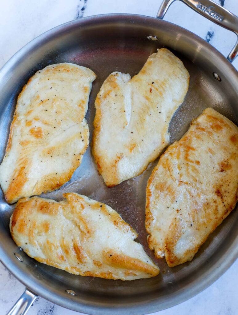Pan searing chicken breasts.