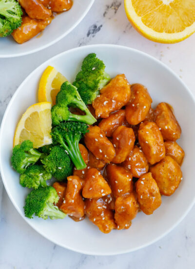 A plate of orange chicken with broccoli.