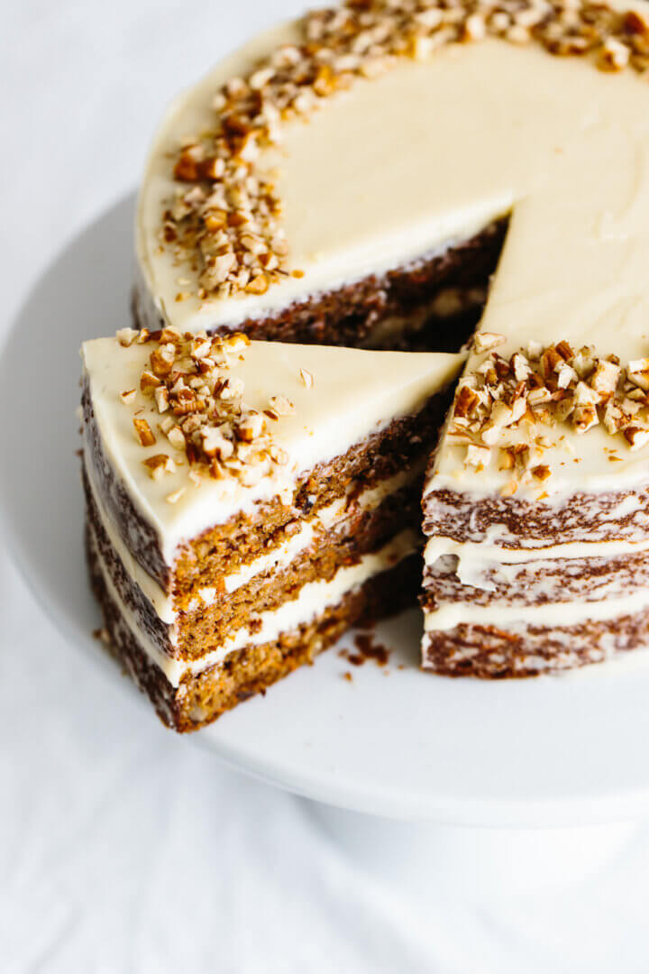 Gluten-free carrot cake on a cake stand.
