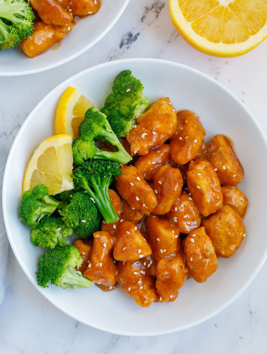 A plate of orange chicken with broccoli.