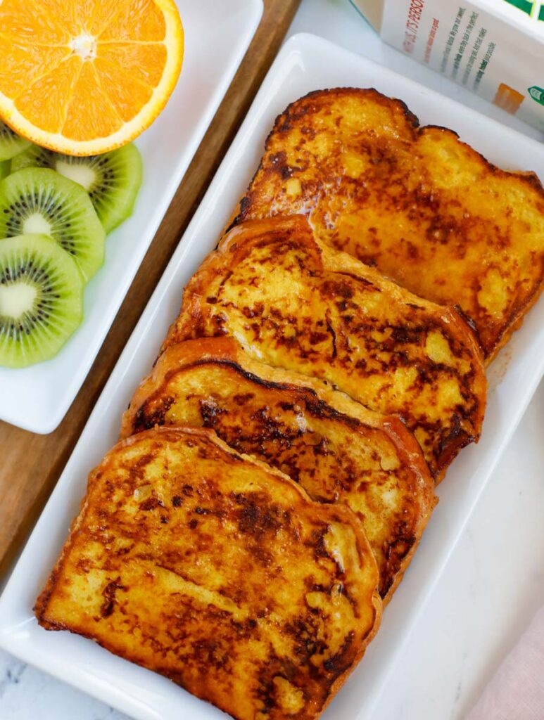 A platter of four orange french toast.
