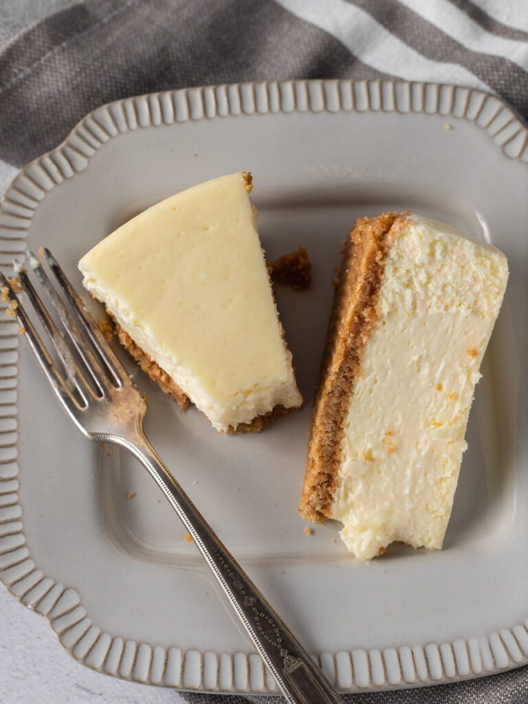 Overhead photo of two slices of New York style cheesecakes.