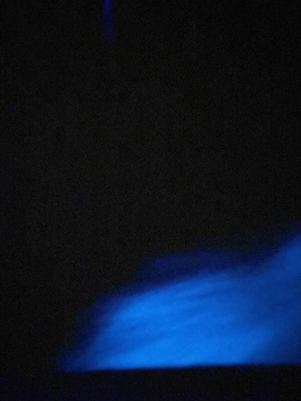 Ocean at night lighting up a blue color because of bioluminescence.