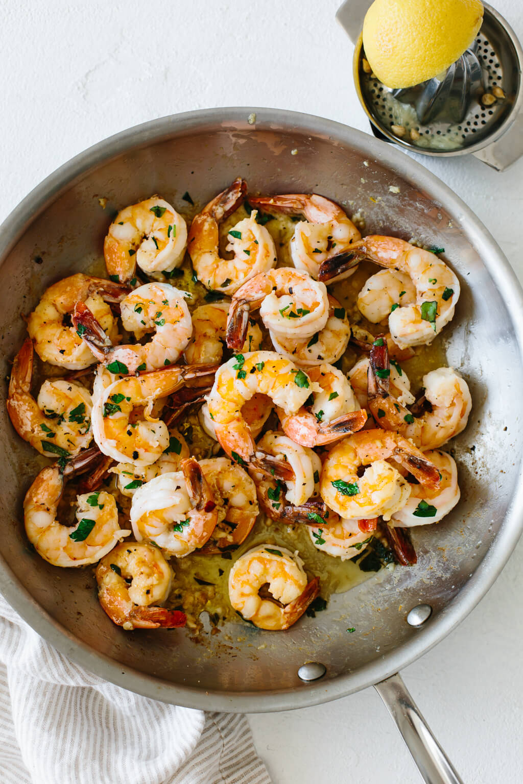Shrimp sauteed in a pan with garlic and butter.