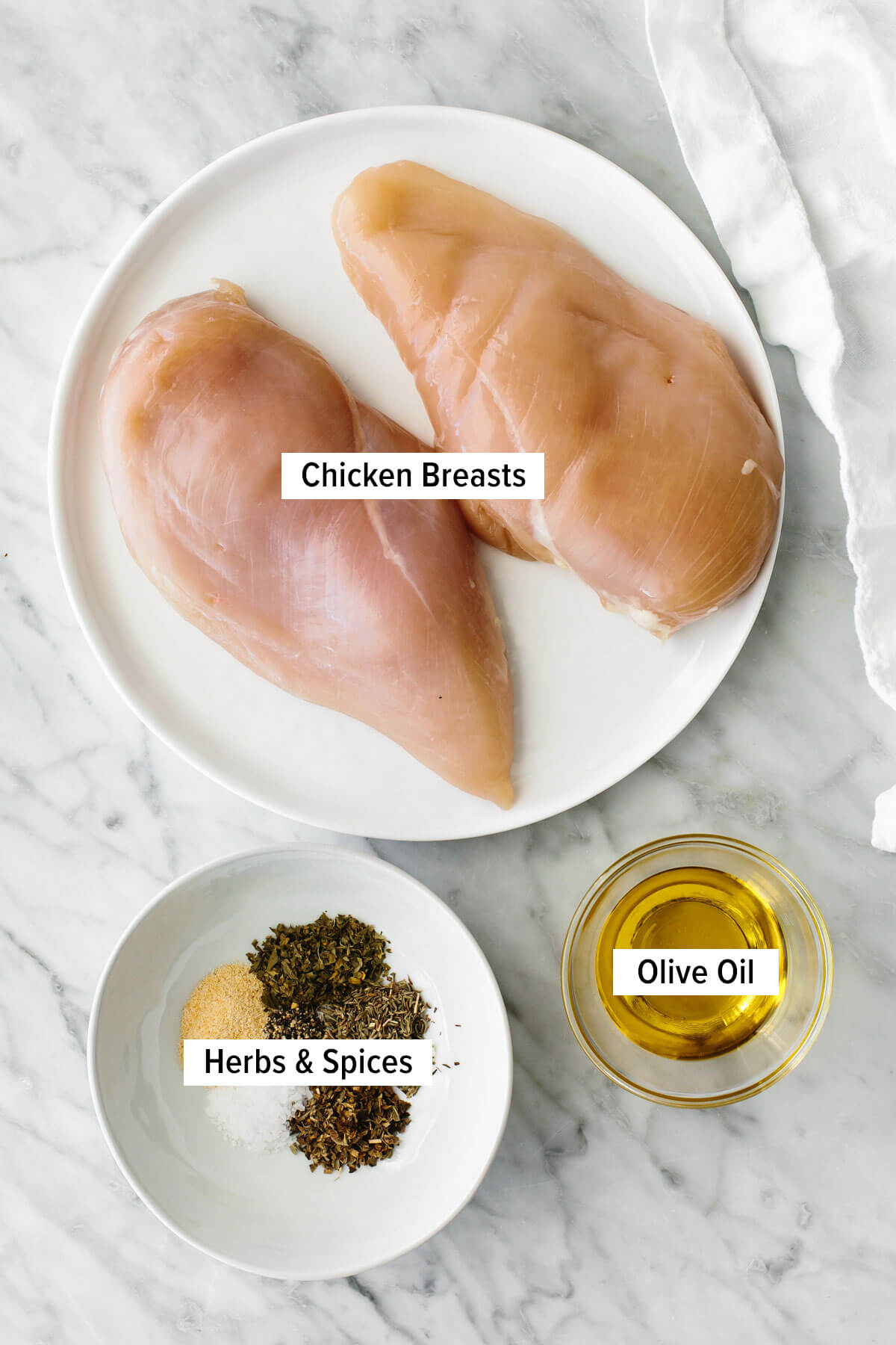 Ingredients for herb baked chicken on a table.