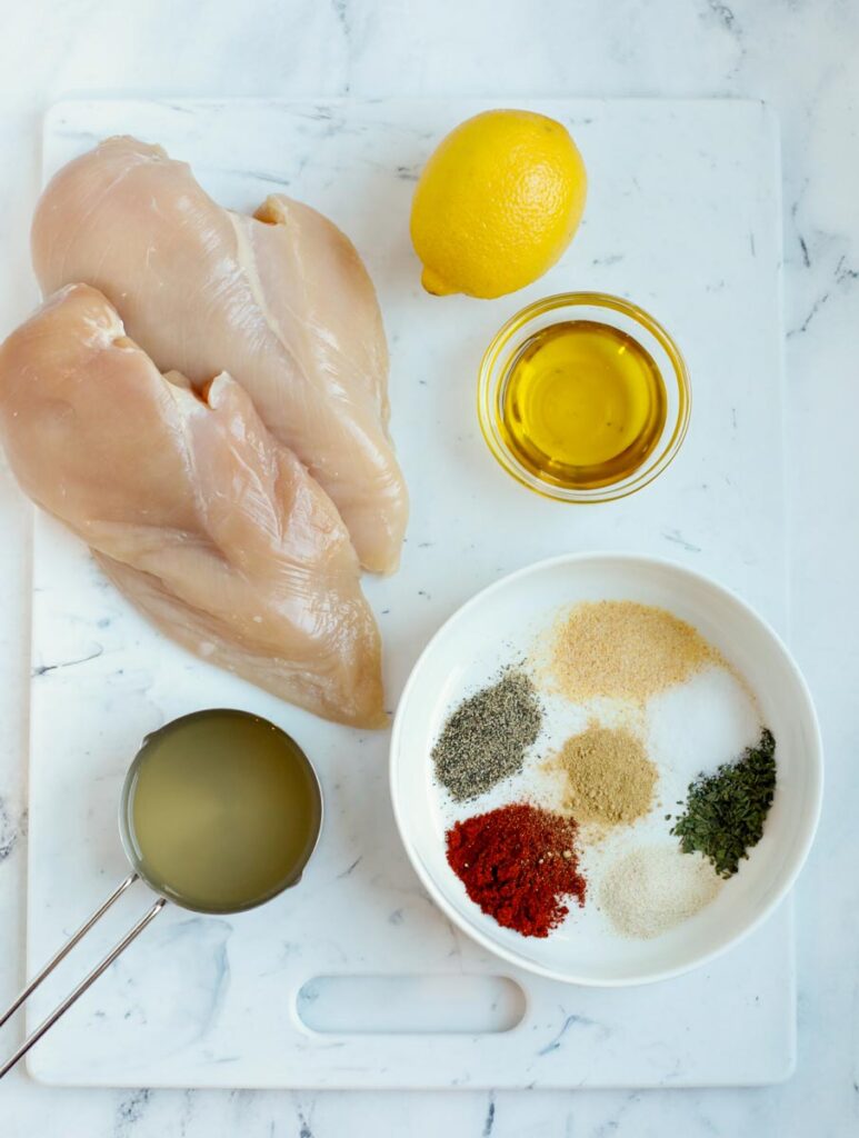Overhead view of ingredients needed to make oven baked chicken breasts.