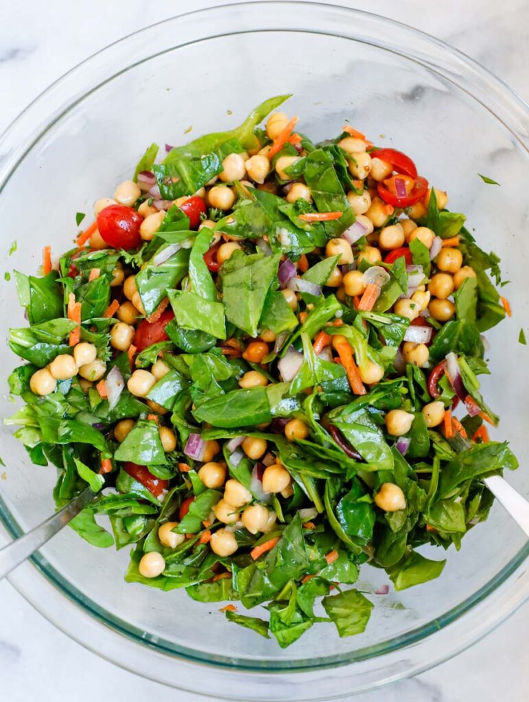 Spinach chickpea salad tossed together.