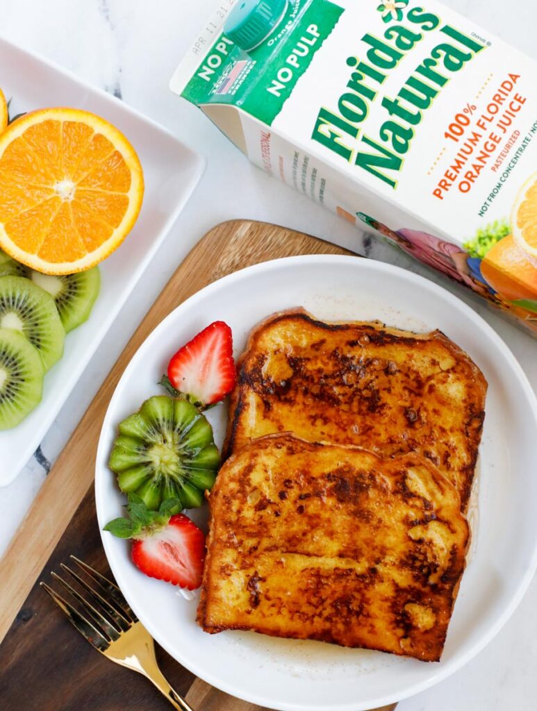 A plate of french toast made with orange juice.