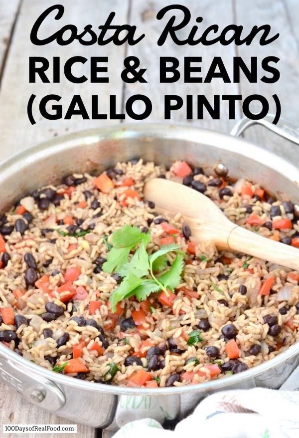 Costa Rican rice and beans (Gallo Pinto) in a saute pan with wooden spoon.