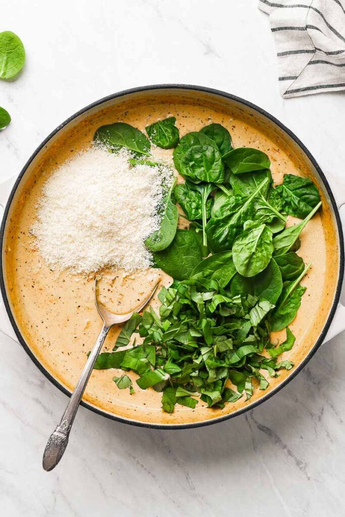 parmesan and spinach added to the creamy sauce