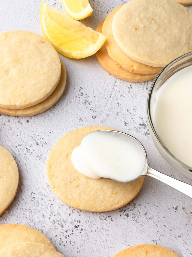 lemon icing being placed on a cookie