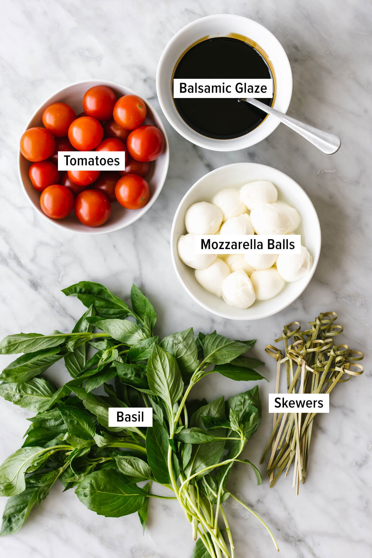 Ingredients for caprese skewers on a table.