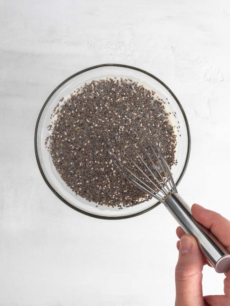 chia being mixed into almond milk