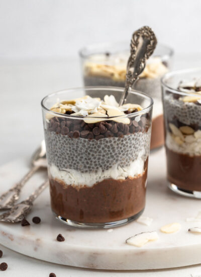 front view shot of almond joy chia pudding with a spoon in the cup