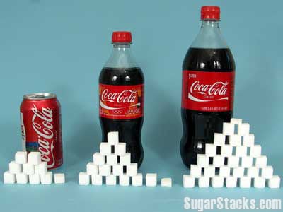 bottles of coke with sugar cubes in front