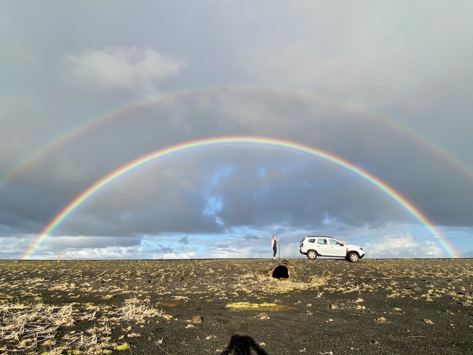 Double rainbow over an open field in Iceland. 