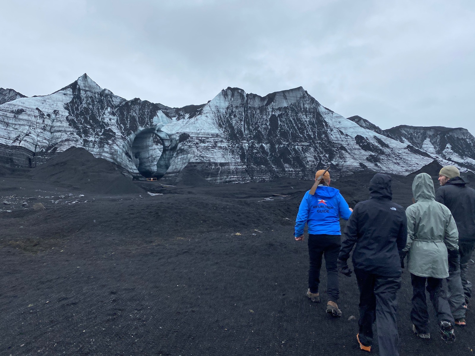 Family and tour guide walking through the lava fields in Iceland. 