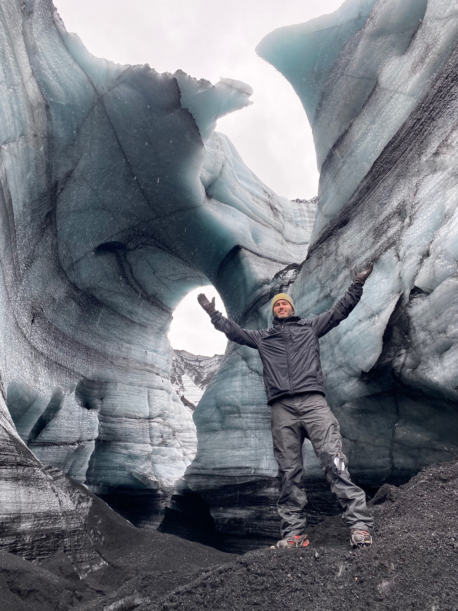 Father posing in ice caves in Iceland. 