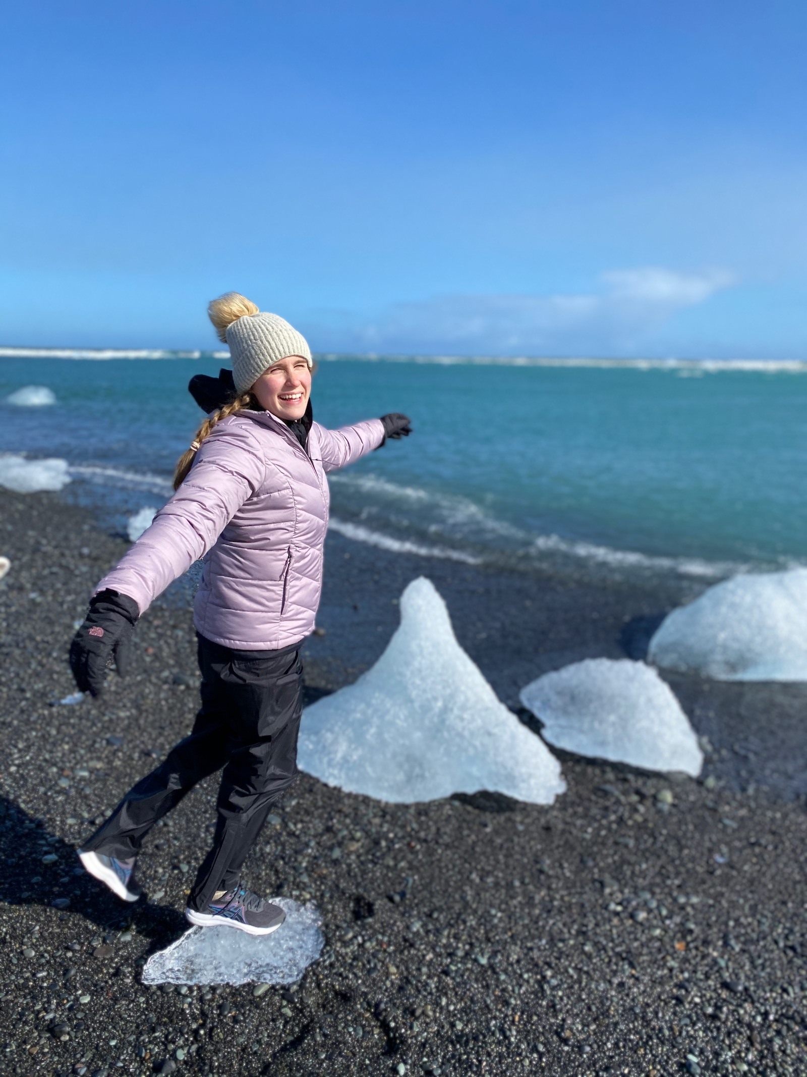 Teen girl posing at Diamond Beach in Iceland. 