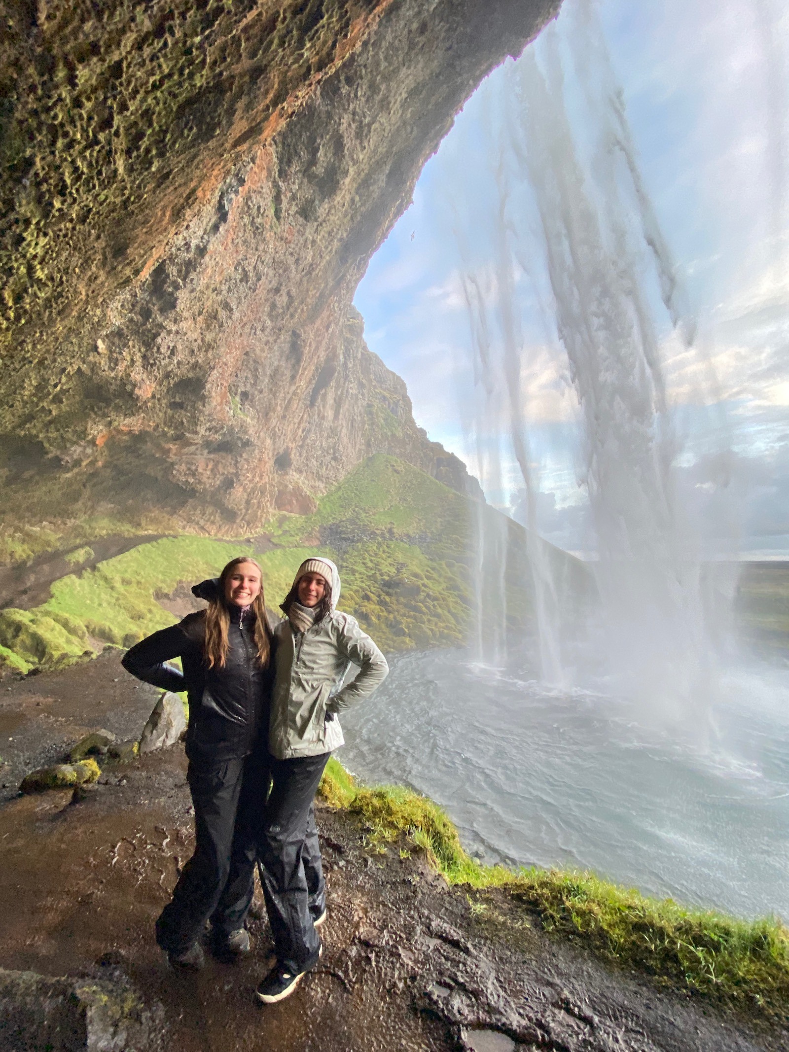 Sisters posing at Seljalandsfoss Falls near Vik in Iceland. 