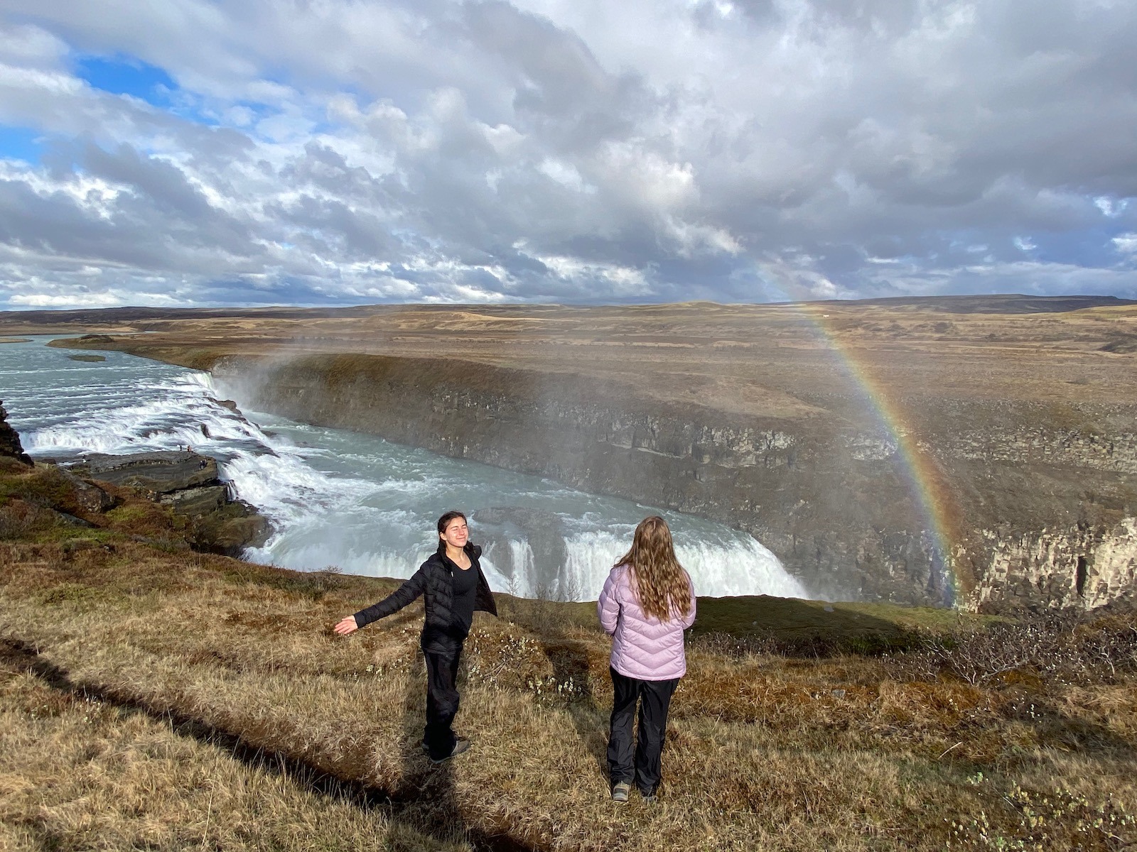 Sisters enjoying the scenic view at Gullfoss Falls on the Golden Circle in Iceland. 