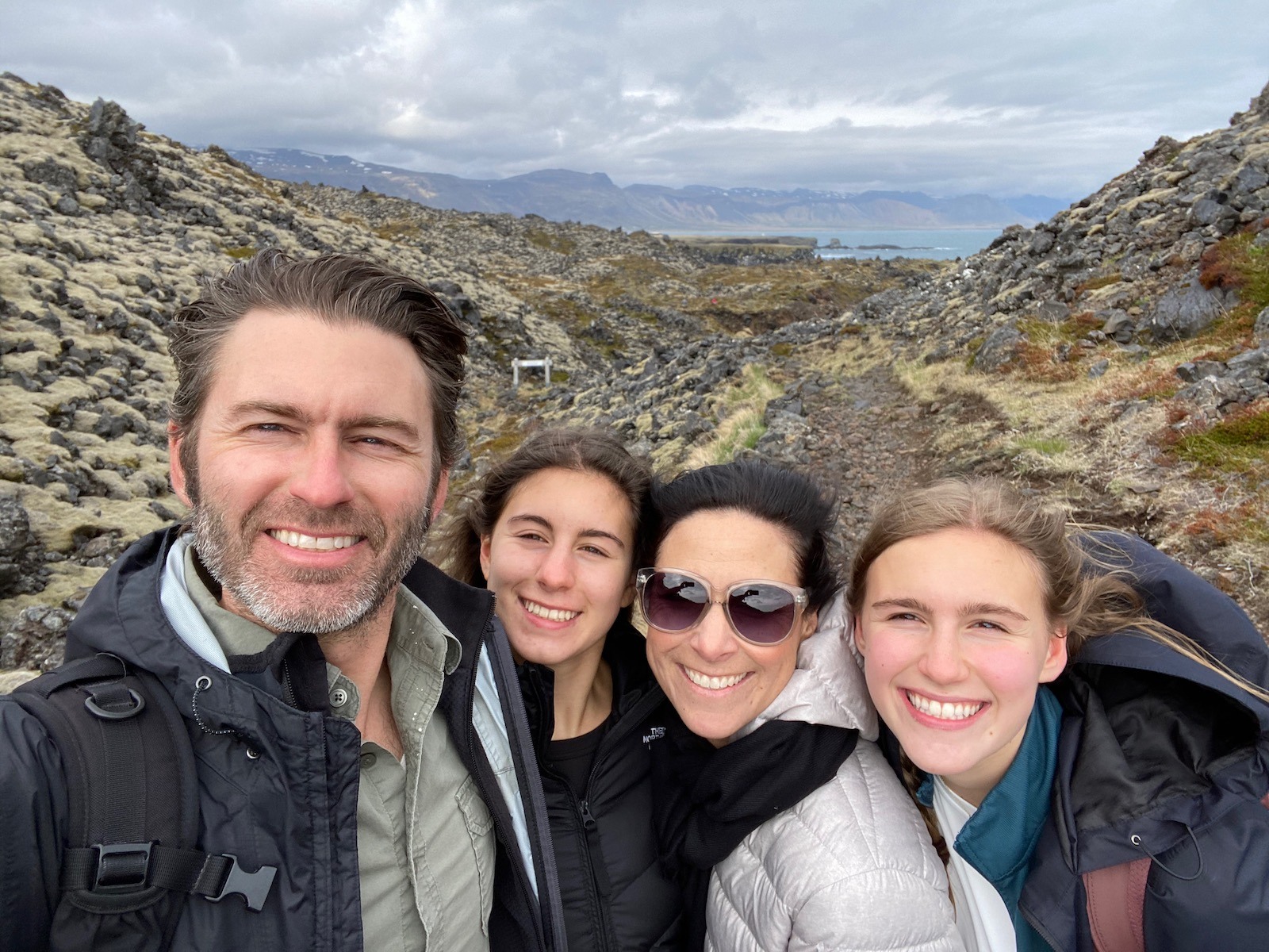 Family portrait with scenic views in the background in Iceland. 