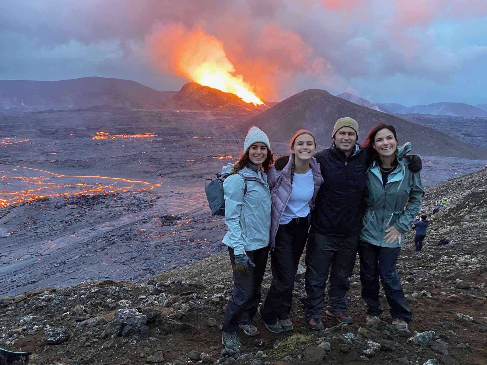 Family posing in front of erupting Fagradalsfjall Volcano. 