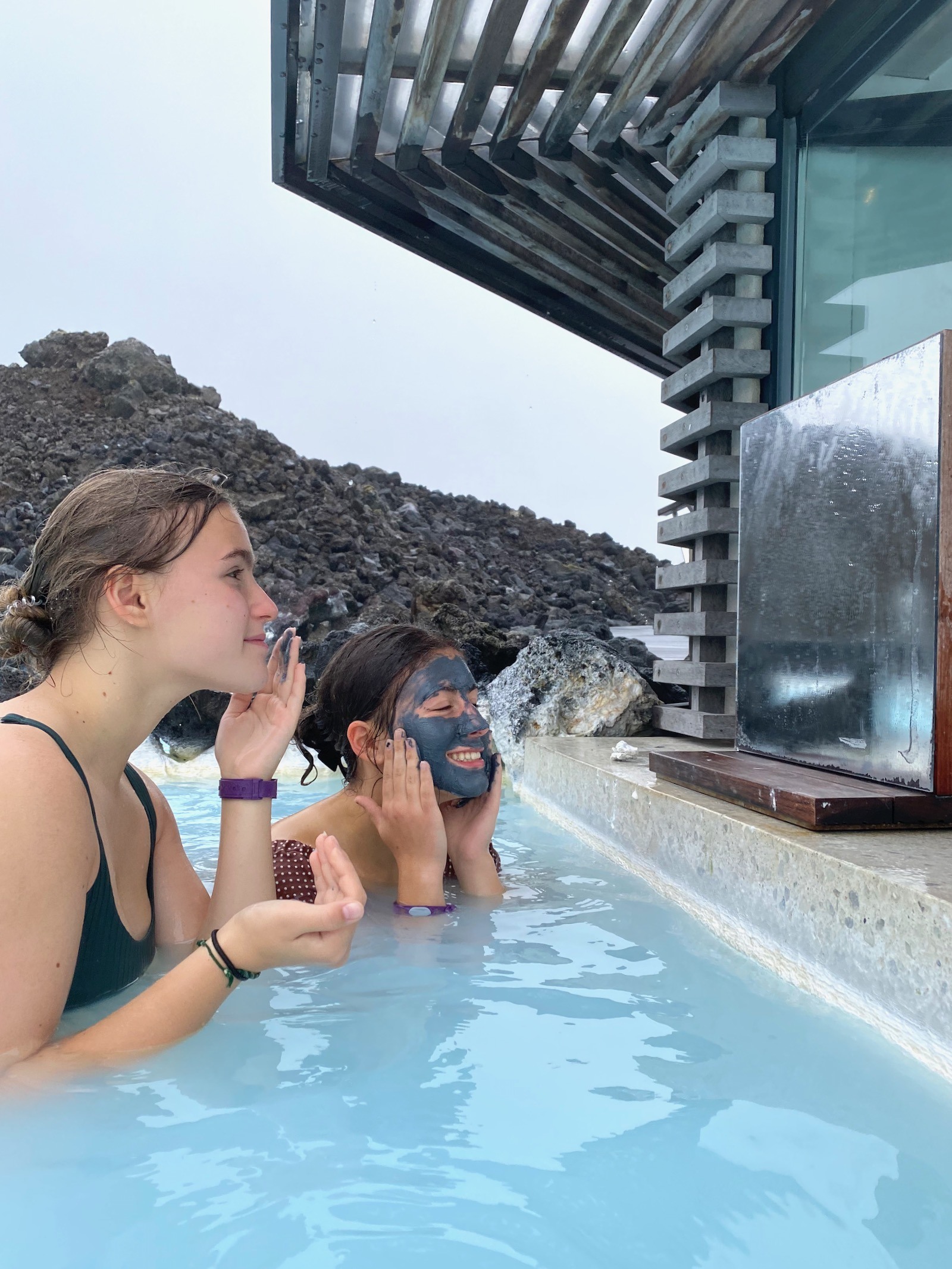 Sisters applying mud mask in the Blue Lagoon in Iceland. 