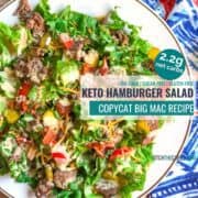 keto hamburger salad on a white plate and blue cloth