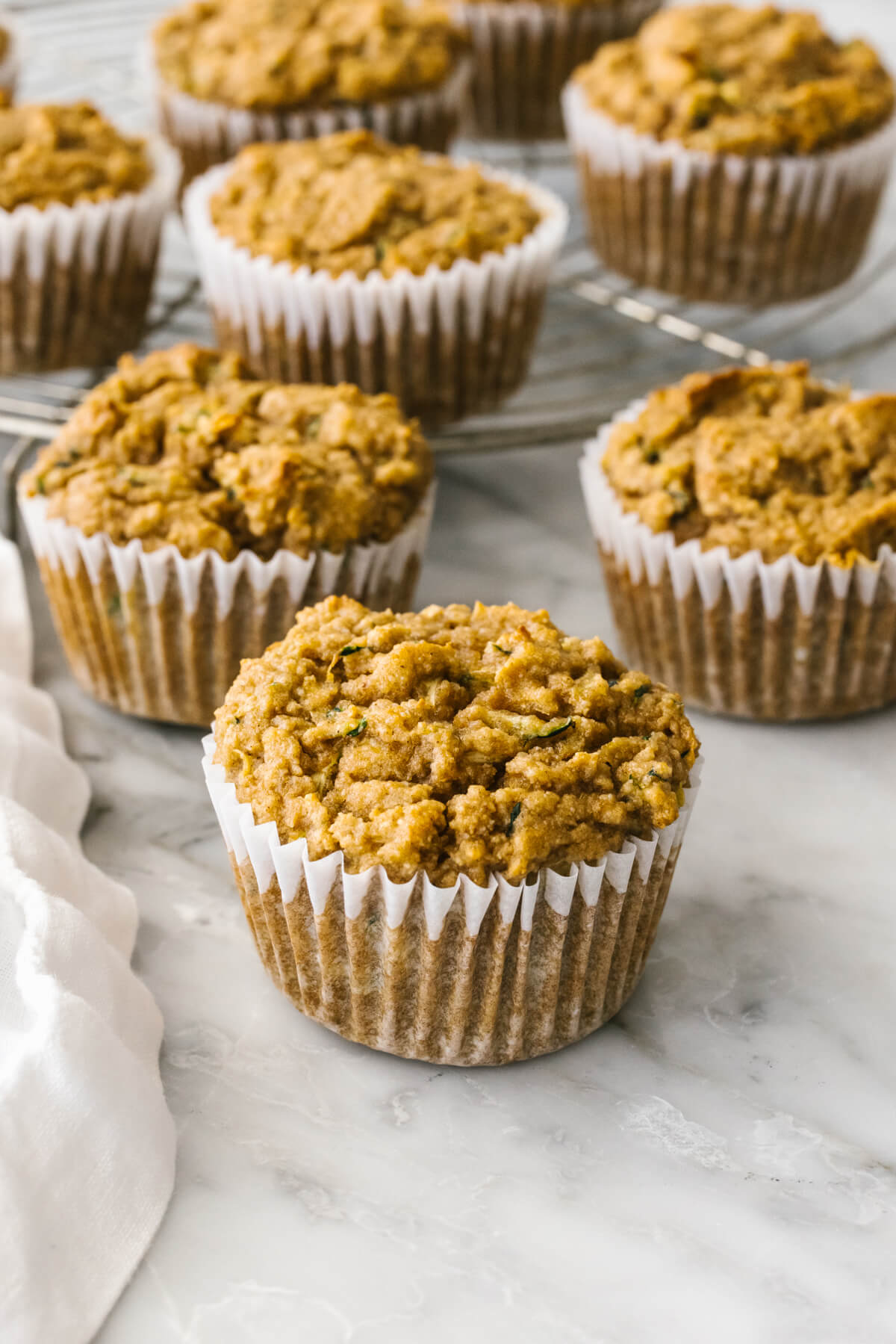 Zucchini muffins spread out on a table