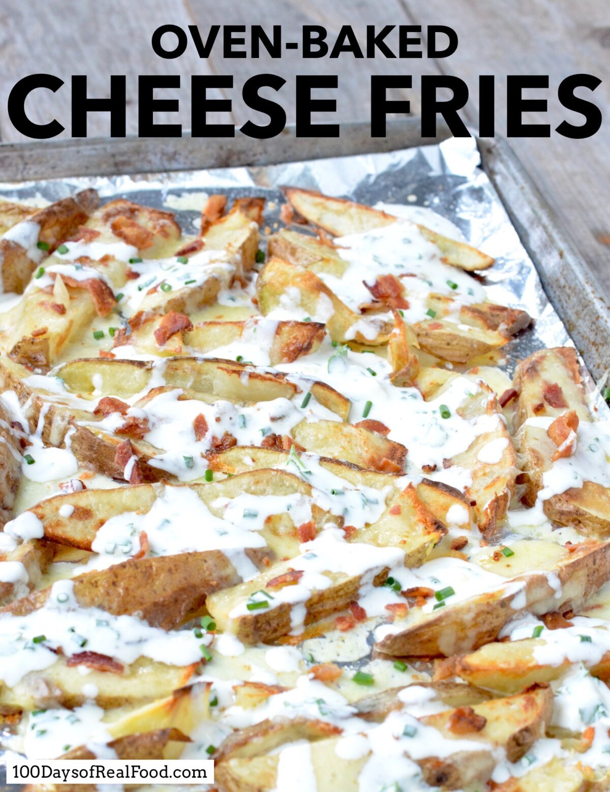 Sliced potatoes topped with cheese, bacon, and homemade ranch dressing on a baking sheet. 