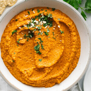 Romesco sauce in a bowl next to parsley