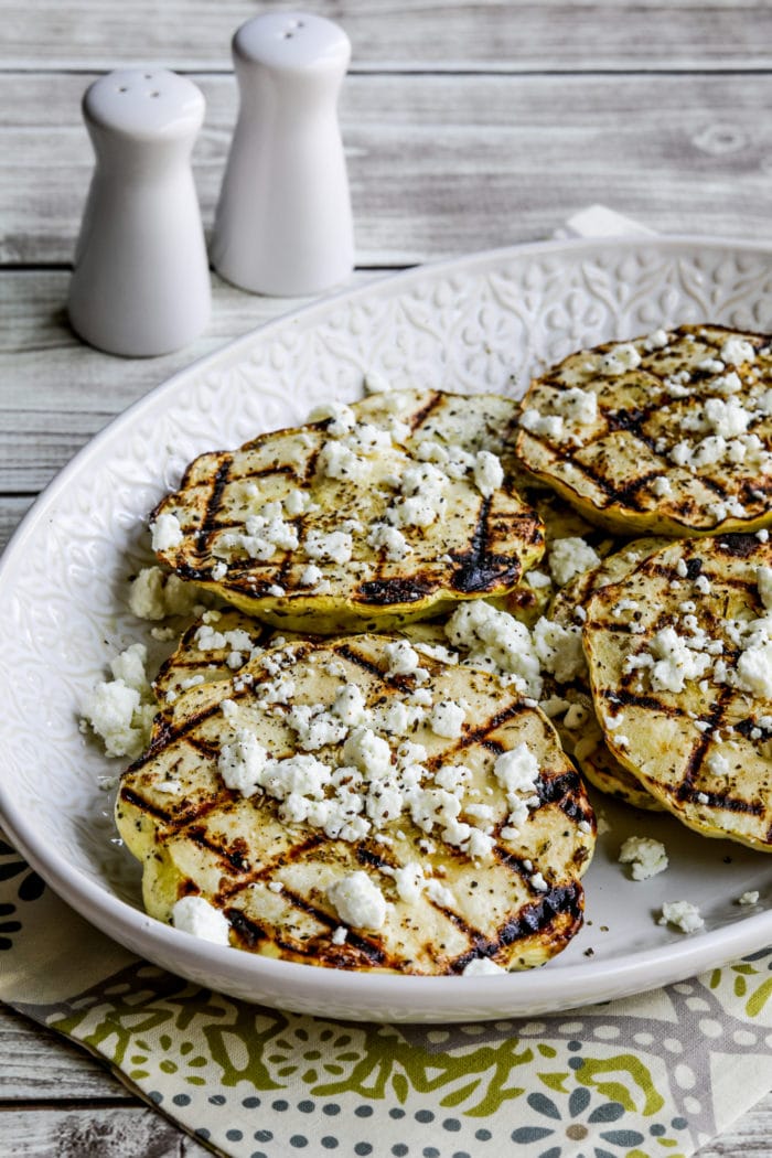 Grilled Patty Pan Squash in serving dish with crumbled goat cheese