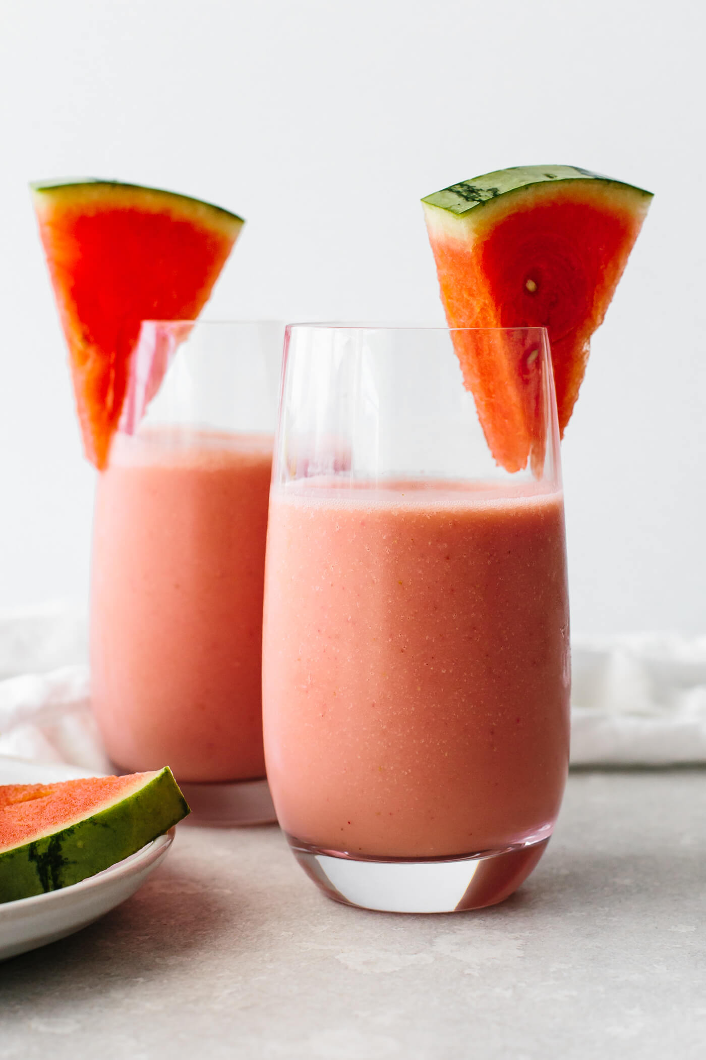 Watermelon smoothies in glasses with fresh watermelon