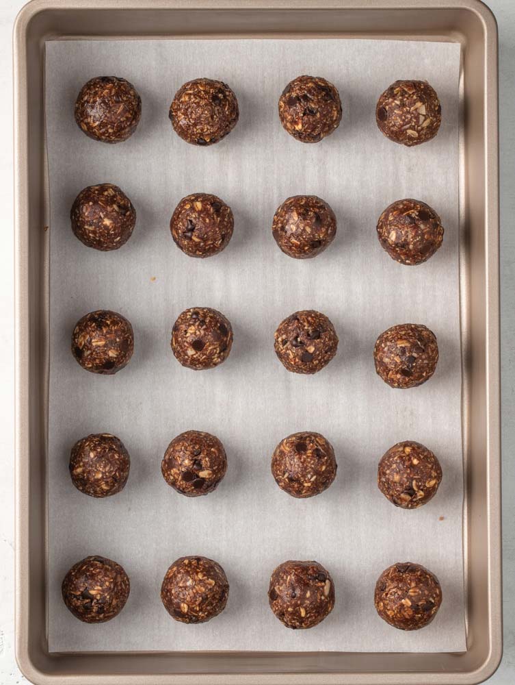 energy balls laid out on a sheet pan for chilling