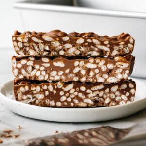 A stack of chocolate crunch bars on a plate.