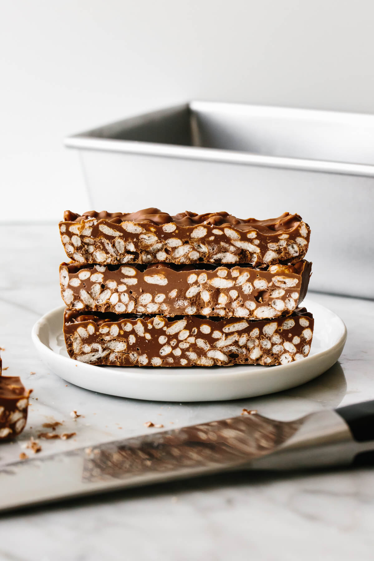 Chocolate crunch bars piled on each other on a plate.