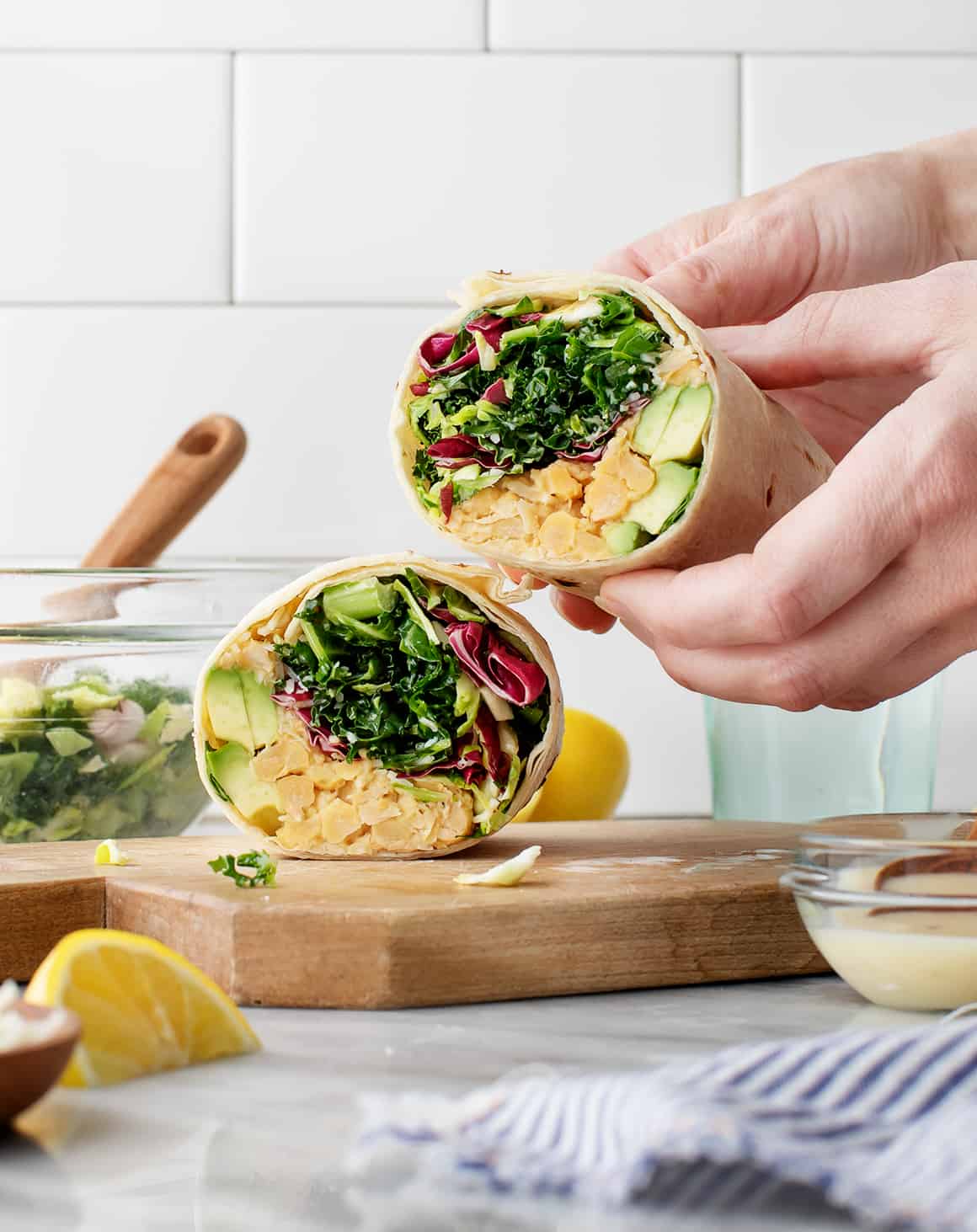 Hands holding sliced healthy lunch wraps