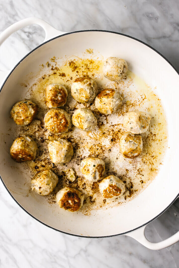 Searing turkey meatballs in a pan