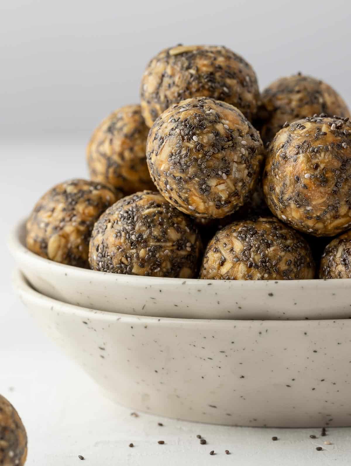 a bunch of energy balls in a white bowl