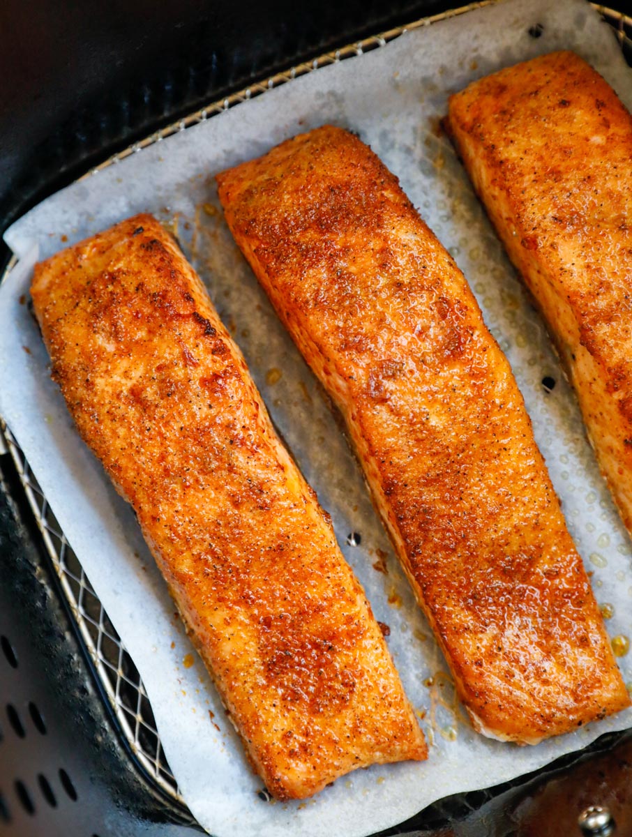 Cooked salmon fillets in an air fryer.