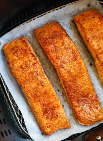 Cooked salmon fillets in an air fryer.