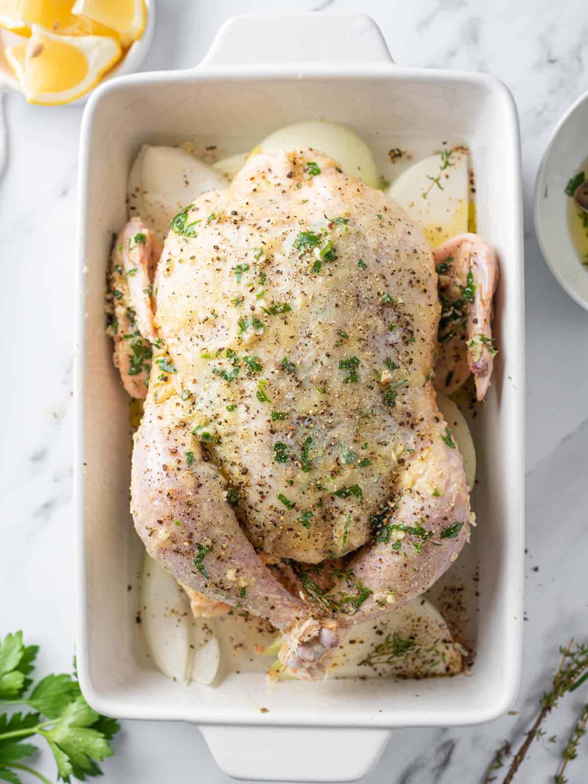 Whole chicken rubbed with herbs and butter.