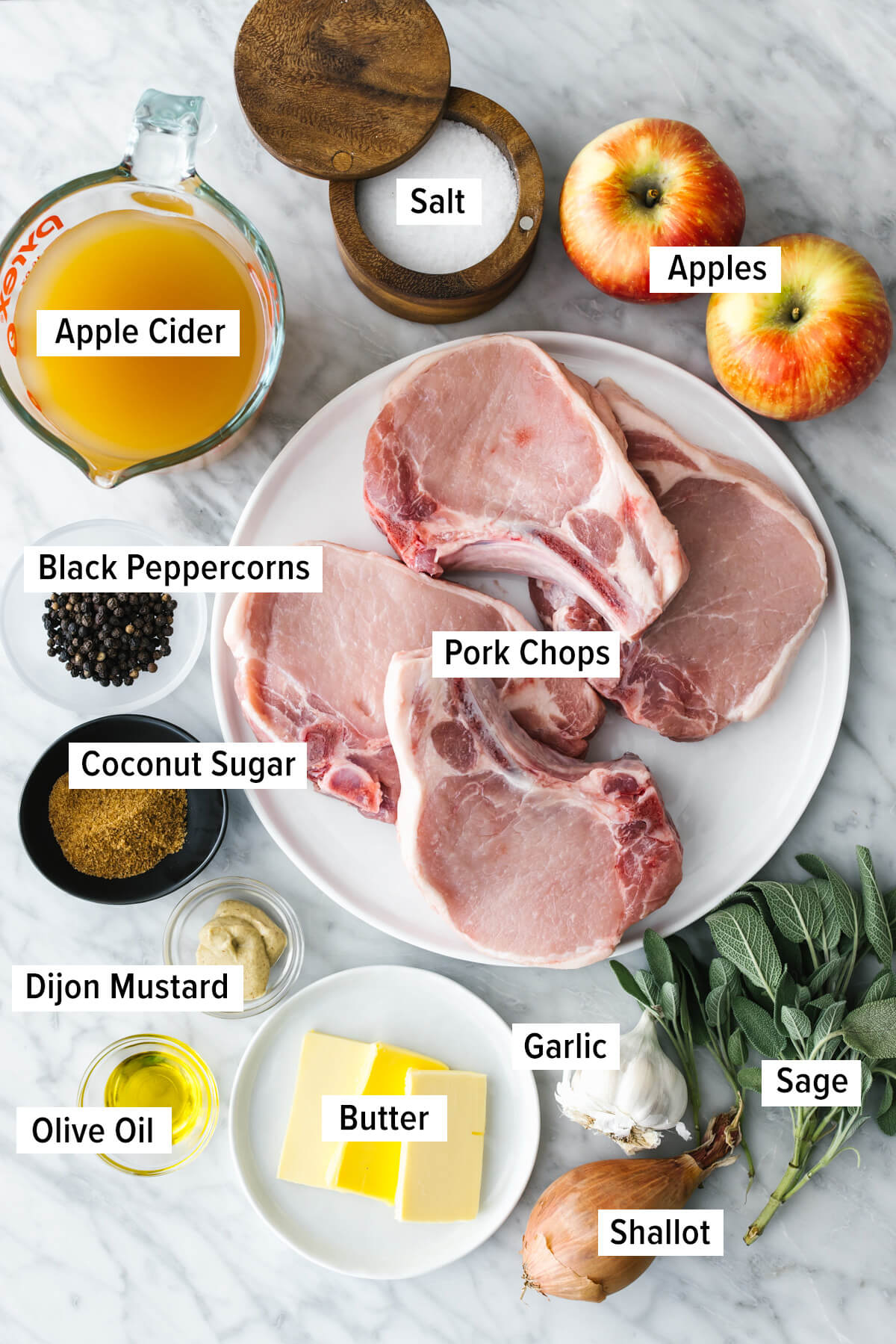 Ingredients for apple cider sage pork chops on table.