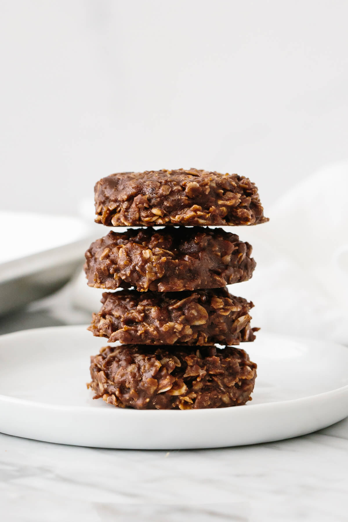 No bake cookies stacked on top of each other on a plate.