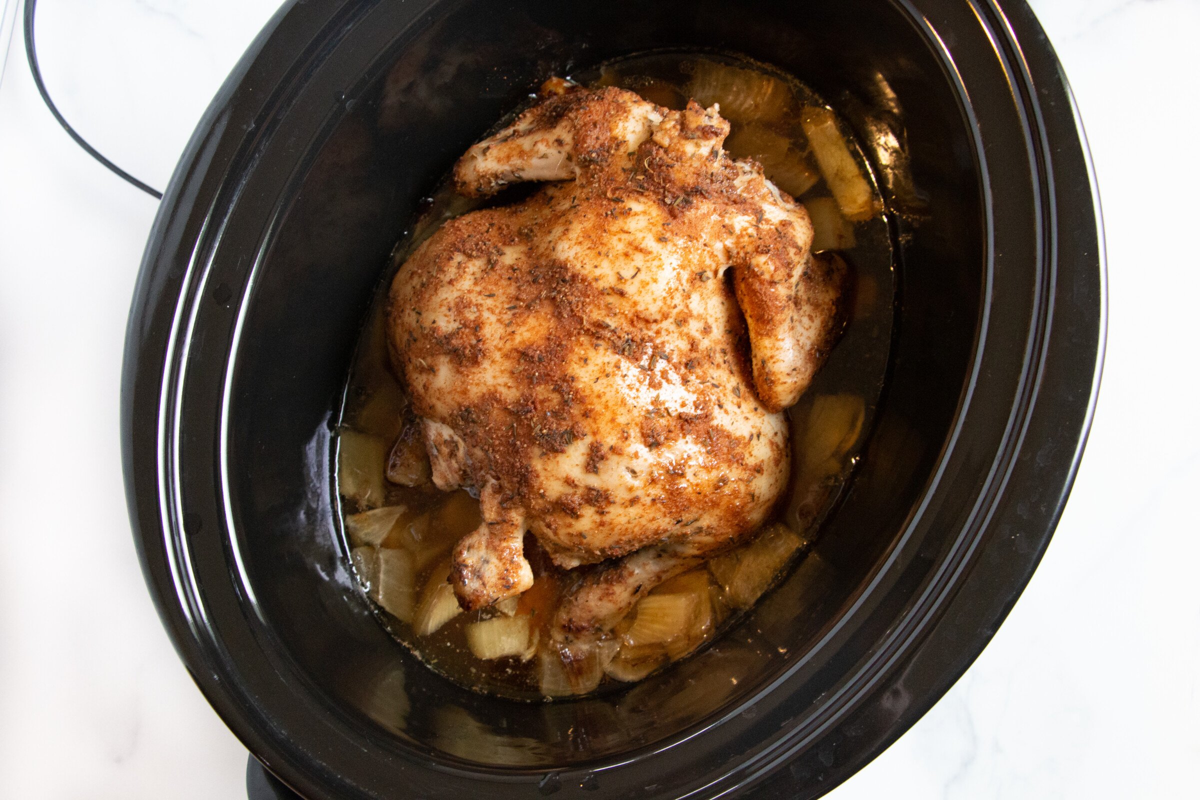Cooked whole chicken in a crock pot