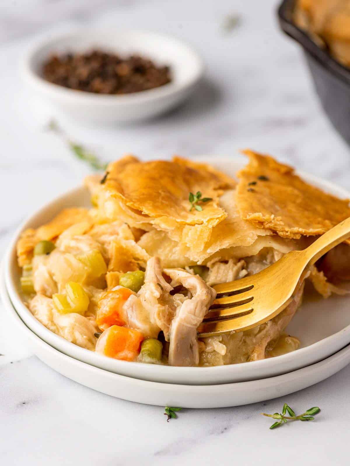 fork poking into the chicken from the pot pie
